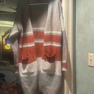 Medium long cardigan sweater.  Grey and rust color